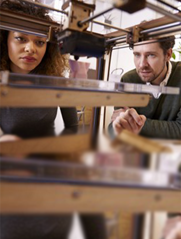 A Man and a Woman Looking at a 3D Printer